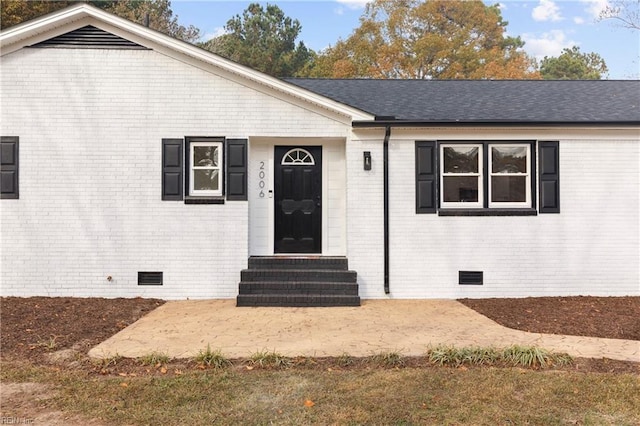 exterior space featuring a shingled roof, entry steps, crawl space, and brick siding