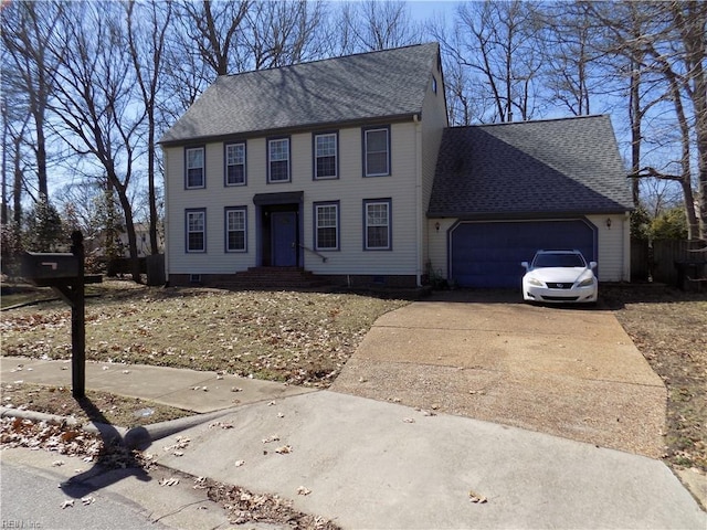 colonial house featuring a garage, concrete driveway, and a shingled roof