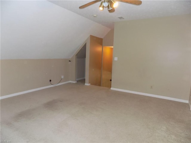 additional living space featuring vaulted ceiling, ceiling fan, carpet floors, and baseboards