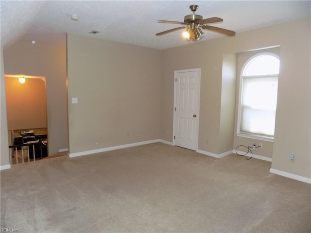 empty room with light colored carpet, ceiling fan, and baseboards