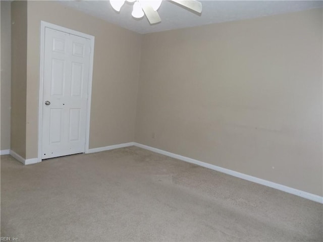 empty room with light carpet, ceiling fan, and baseboards