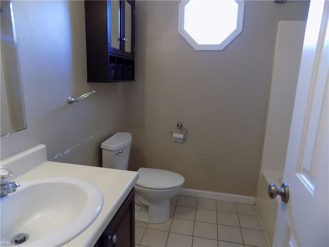 full bathroom featuring vanity, tile patterned flooring, toilet, and baseboards