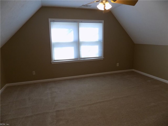 additional living space with lofted ceiling, carpet floors, and baseboards