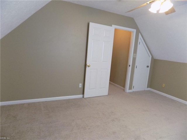 bonus room with lofted ceiling, baseboards, a ceiling fan, and light colored carpet