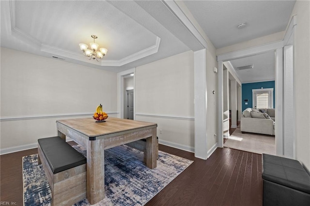 dining space featuring a raised ceiling, baseboards, a notable chandelier, and dark wood-style flooring