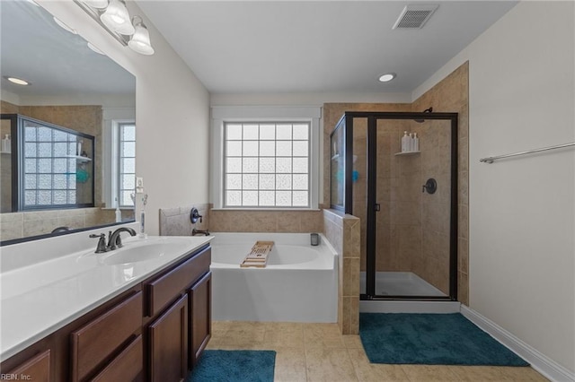 full bathroom with a stall shower, visible vents, a garden tub, and vanity