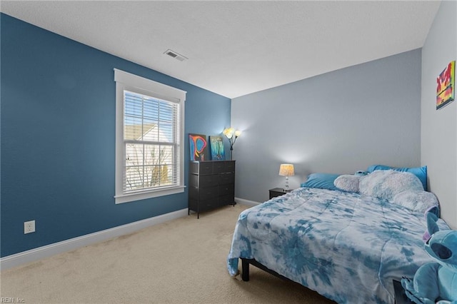 bedroom with carpet, visible vents, and baseboards