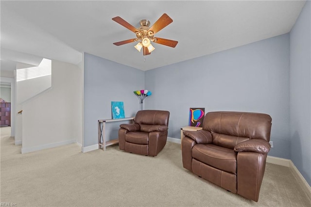 sitting room featuring carpet flooring, ceiling fan, and baseboards