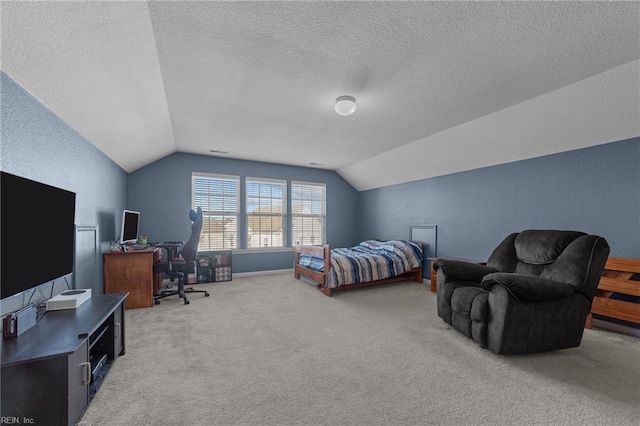 carpeted bedroom with a textured wall, vaulted ceiling, and a textured ceiling