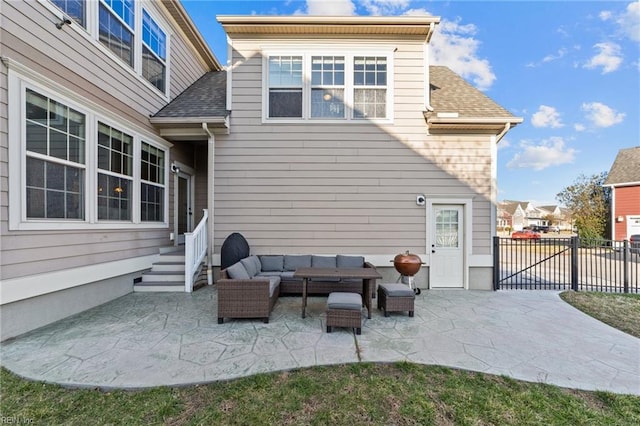 rear view of property featuring a patio, roof with shingles, outdoor lounge area, and fence