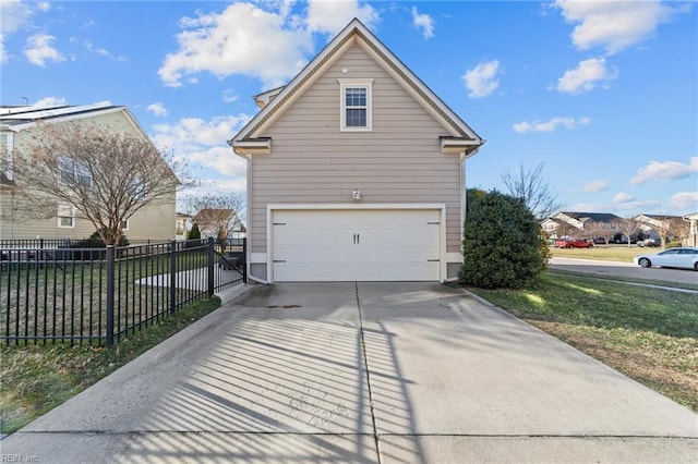 view of property exterior featuring concrete driveway, an attached garage, and fence