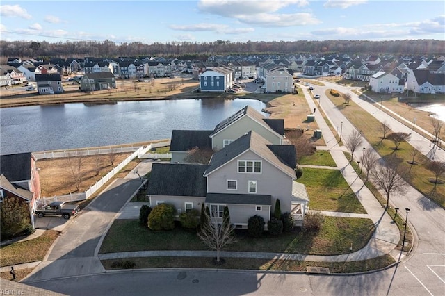 birds eye view of property with a water view and a residential view