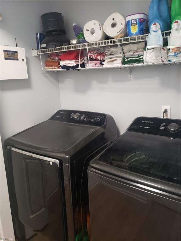 washroom with laundry area and washer and dryer