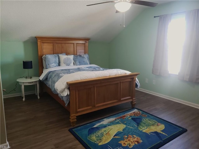 bedroom with dark wood-style floors, lofted ceiling, ceiling fan, and baseboards