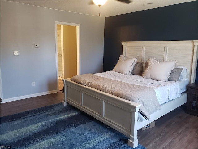 bedroom featuring baseboards and dark wood-style flooring