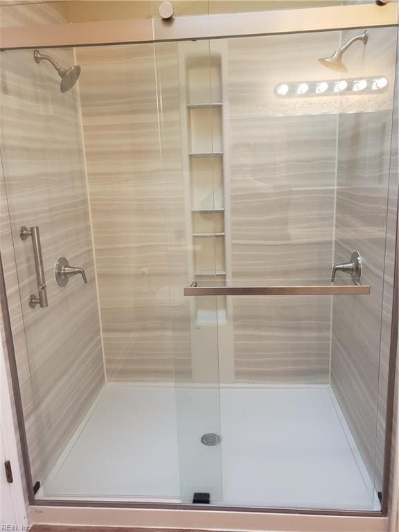 full bath featuring a shower stall