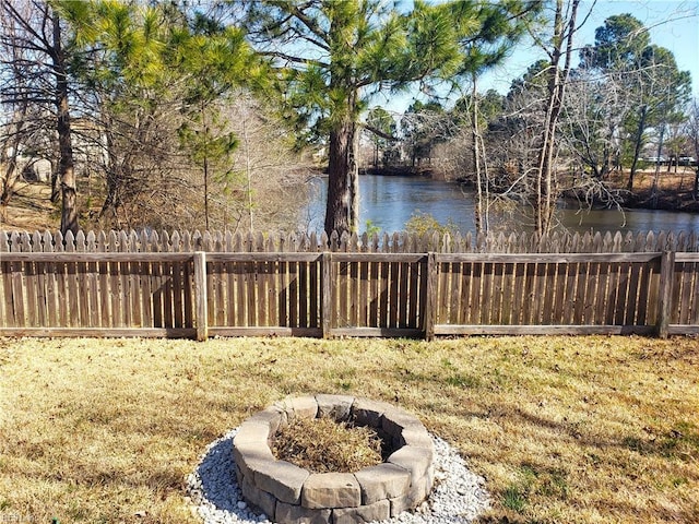 view of yard featuring a water view and fence