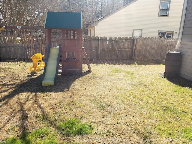 view of yard with a playground and a fenced backyard