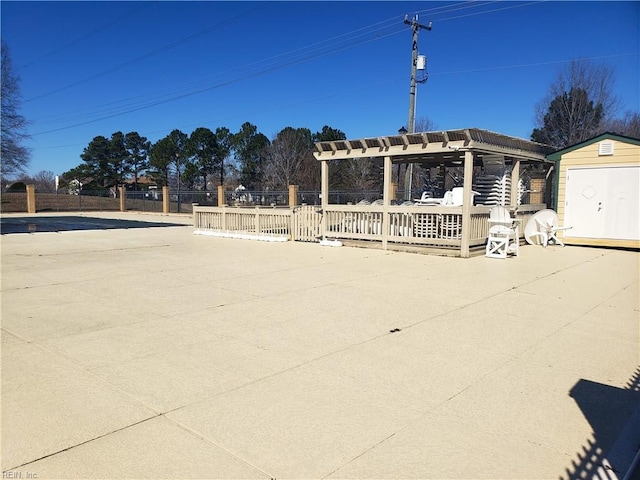 exterior space featuring a storage unit, fence, a pergola, and an outdoor structure