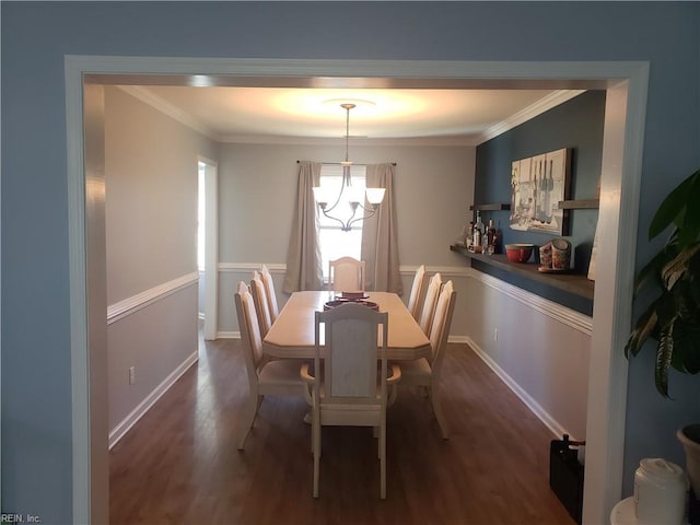 dining area featuring dark wood-style floors, baseboards, a chandelier, and crown molding