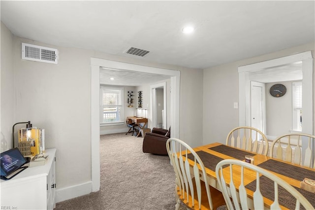 dining space featuring carpet, visible vents, and baseboards