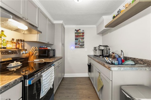 kitchen featuring stainless steel range with electric cooktop, a textured ceiling, crown molding, under cabinet range hood, and open shelves