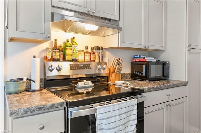 kitchen with stainless steel electric range oven and under cabinet range hood