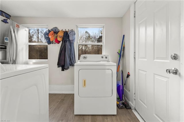 laundry area with laundry area, independent washer and dryer, and a wealth of natural light