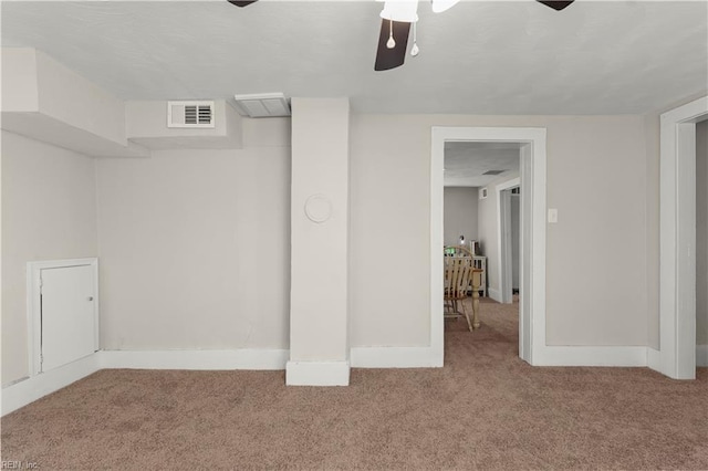 interior space with carpet floors, visible vents, and baseboards