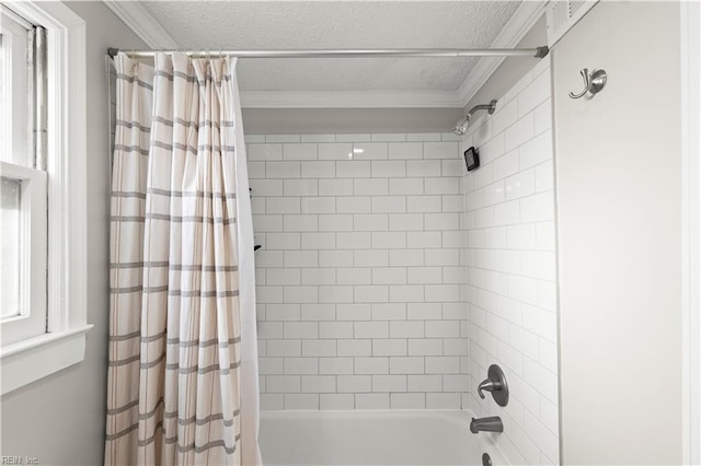 full bathroom featuring shower / bath combo, ornamental molding, and a textured ceiling