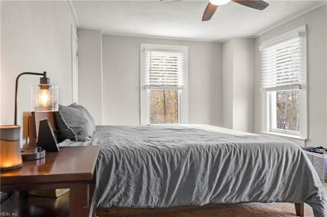 bedroom featuring a ceiling fan and a textured ceiling