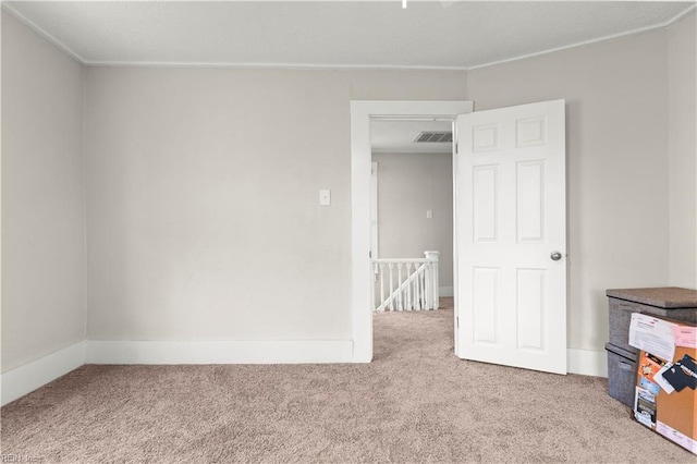 spare room with carpet and visible vents