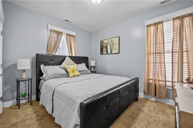 bedroom featuring light colored carpet, visible vents, and baseboards