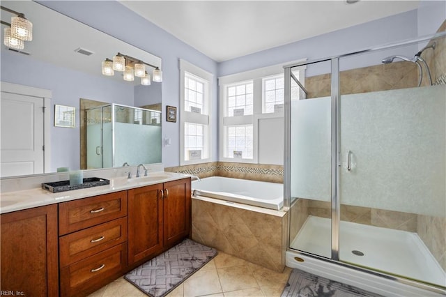 bathroom with visible vents, a sink, tile patterned flooring, a shower stall, and a bath