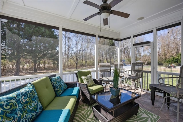 sunroom featuring a ceiling fan