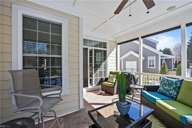 sunroom featuring ceiling fan