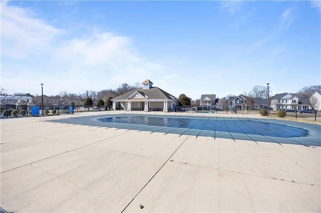 pool featuring a residential view, fence, and a patio