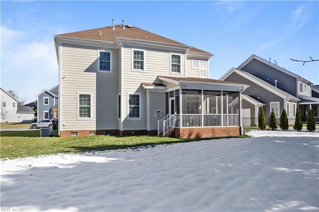 rear view of house featuring a sunroom, a lawn, crawl space, and fence