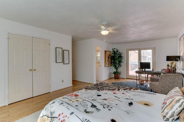 bedroom with a ceiling fan, access to outside, a closet, and light wood-style flooring