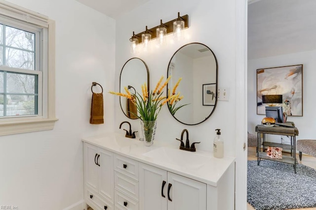 bathroom with a sink and double vanity