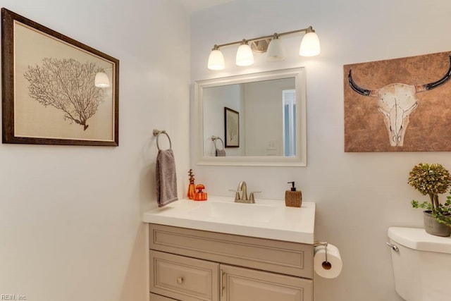 bathroom featuring toilet and vanity