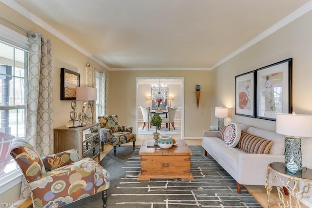 living room with an inviting chandelier, baseboards, and ornamental molding