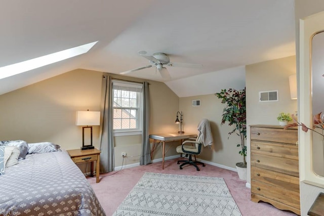 bedroom featuring visible vents, lofted ceiling with skylight, light carpet, ceiling fan, and baseboards