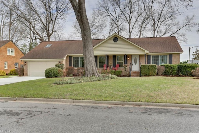 view of front of home featuring a porch, a garage, brick siding, driveway, and a front lawn