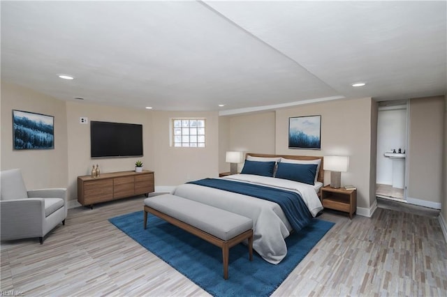 bedroom with light wood finished floors, recessed lighting, and baseboards