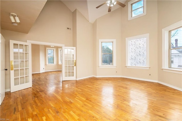 unfurnished room featuring french doors, a wealth of natural light, and light wood-style floors