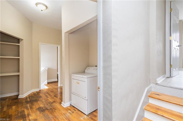 washroom featuring washer / dryer, laundry area, light wood-style floors, and baseboards