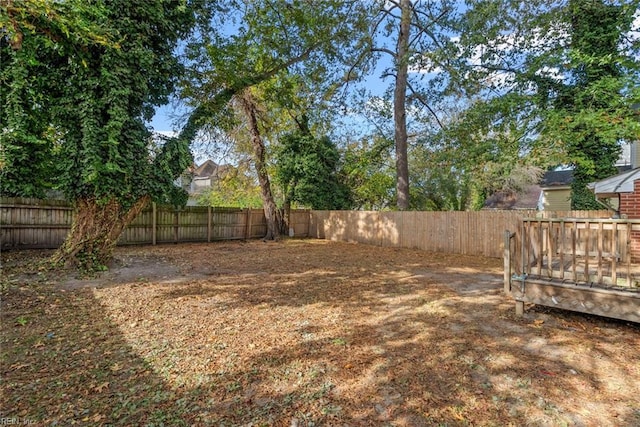 view of yard featuring a fenced backyard and a wooden deck