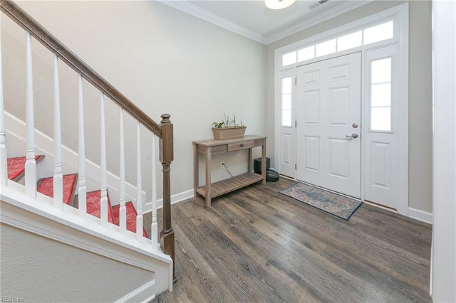 entryway with wood finished floors, visible vents, baseboards, ornamental molding, and stairway