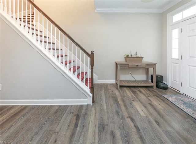 entrance foyer with stairway, baseboards, ornamental molding, and wood finished floors